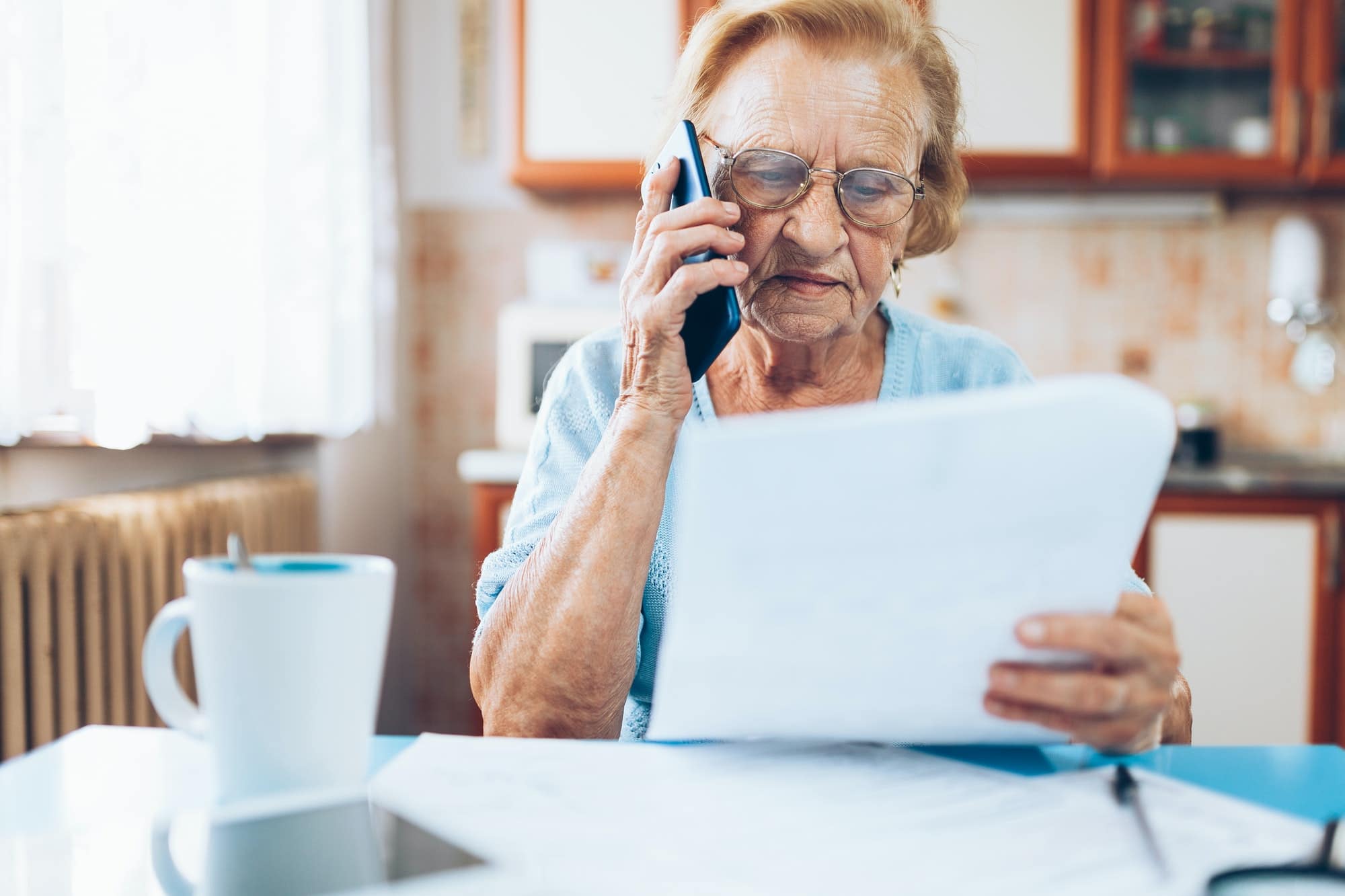 Elderly woman contacting custumer services after recieving a bill