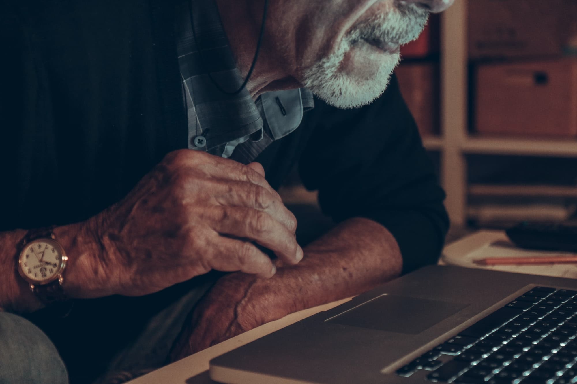 Profile of old man using a laptop